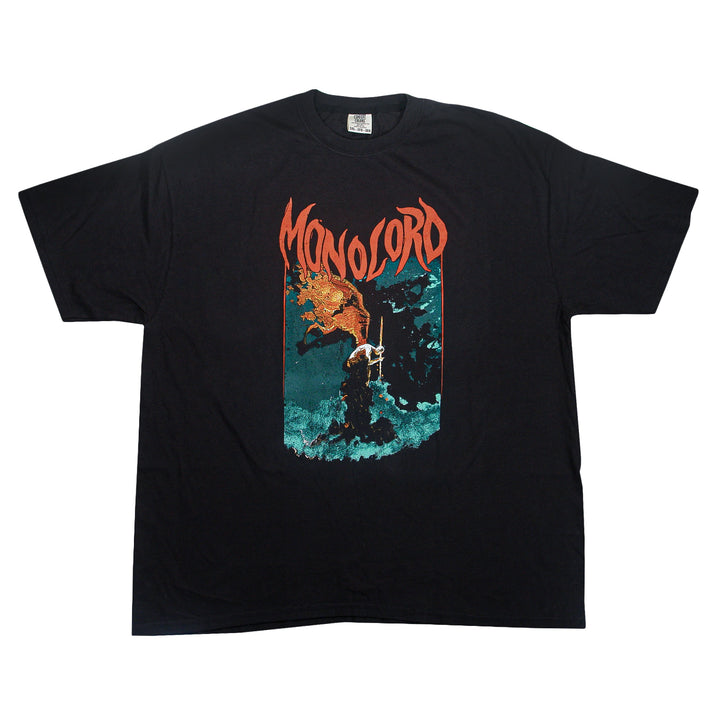 Garment-dyed black ring-spun cotton t-shirt featuring the word Monolord in orange font above an illustration of a figure standing in dark, wavy water with a flaming creature overhead.