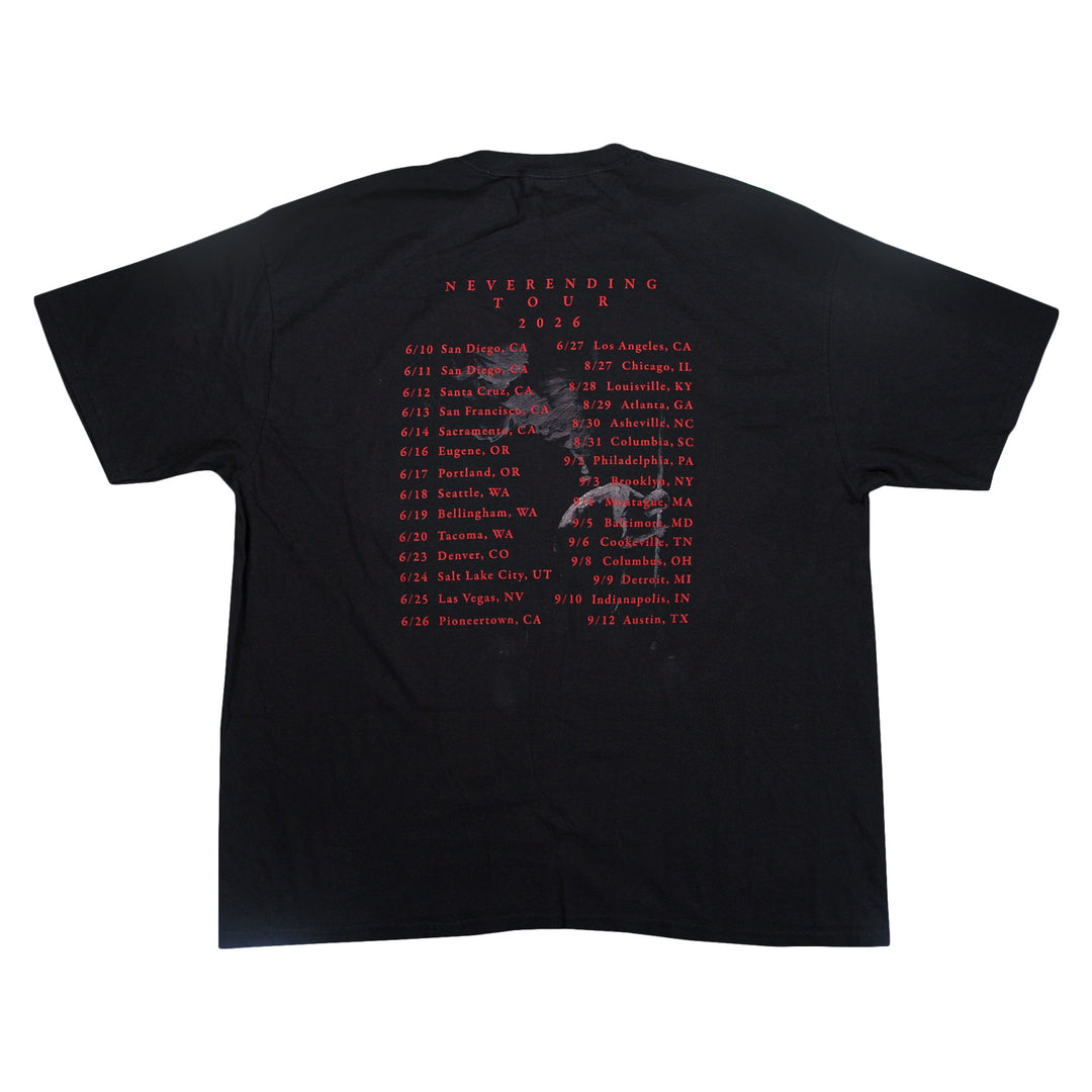 Black Comfort Colors t-shirt with NEVERENDING TOUR 2026 and a list of tour dates and cities printed in red on the back.