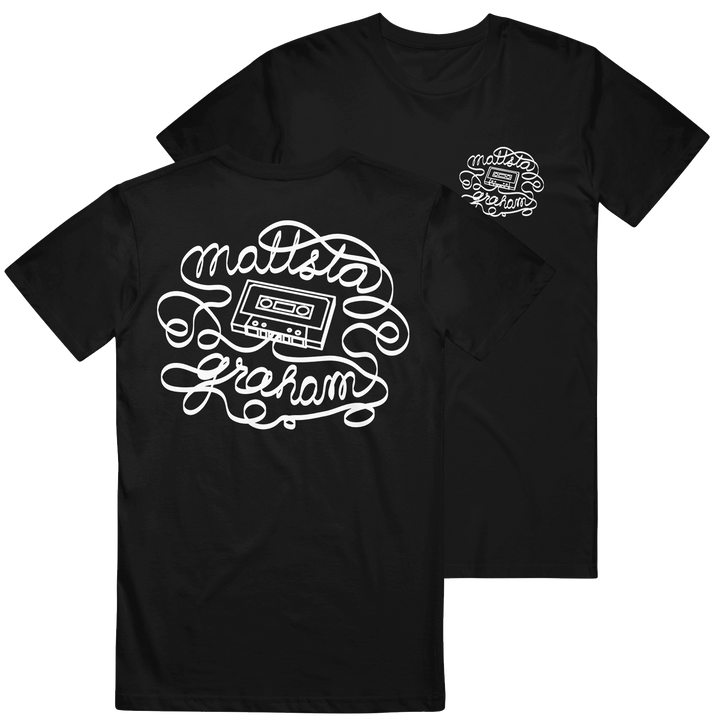 Black t-shirt made from soft U.S. cotton by Mattstagraham, featuring a white cassette tape graphic and the words "Mattsta Graham" in curly script on the back. The relaxed fit ensures everyday comfort, with a smaller matching design on the front left chest—evoking classic American Apparel style.