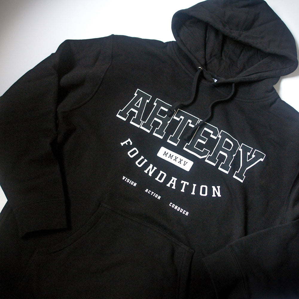 A black midweight pullover fleece hoodie by Artery Foundation featuring "ARTERY FOUNDATION" and "VISION ACTION CONQUER" boldly printed on the front, with "MMXXV" boxed below. Made from soft ring-spun cotton for comfort.