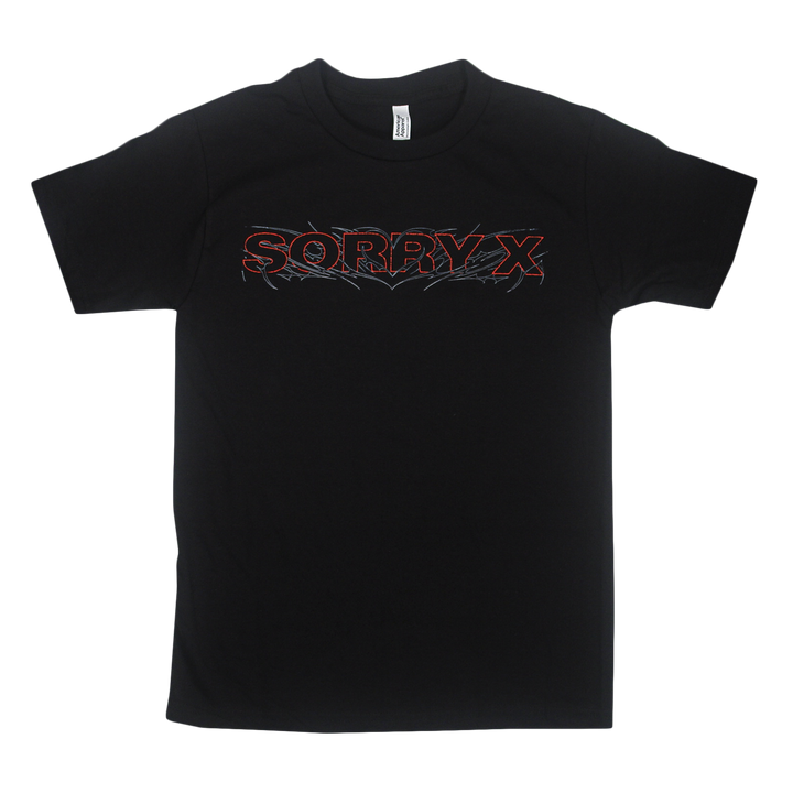 Black American Apparel t-shirt by Sorry X featuring the words “SORRY X” in bold red outlined text across the chest, accented with a spiky, flame-inspired design around the lettering. Made from 100% U.S. cotton, this relaxed fit tee is plain with no additional graphics.