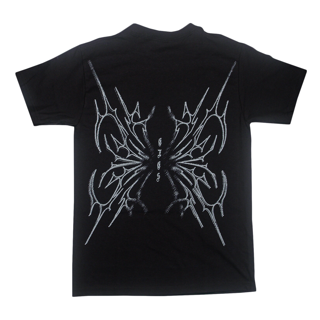 Black t-shirt by Sorry X, crafted from 100% U.S cotton, featuring an abstract, symmetrical white line design on the back that resembles sharp intersecting shapes or wings. Includes small stylized text in the center and offers a relaxed fit inspired by classic American Apparel T-Shirts.