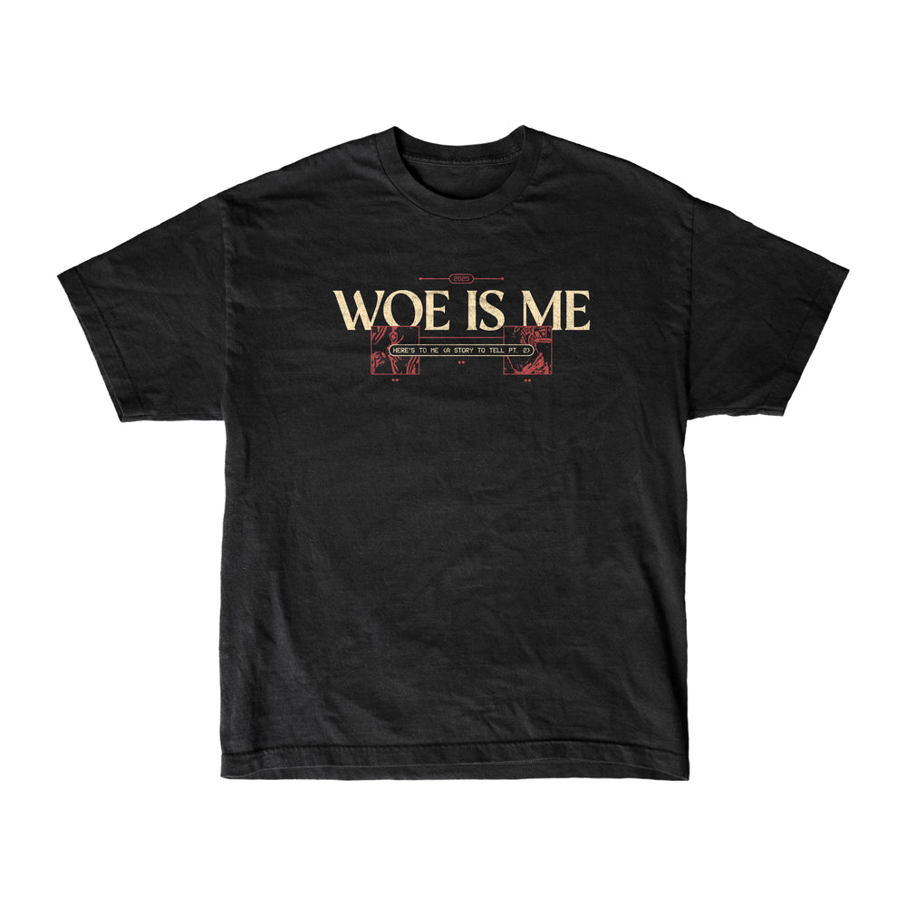 The Woe Is Me black womens-inspired T-shirt features WOE IS ME in bold cream letters with red and cream ornamental lines below, shown on a plain white background.