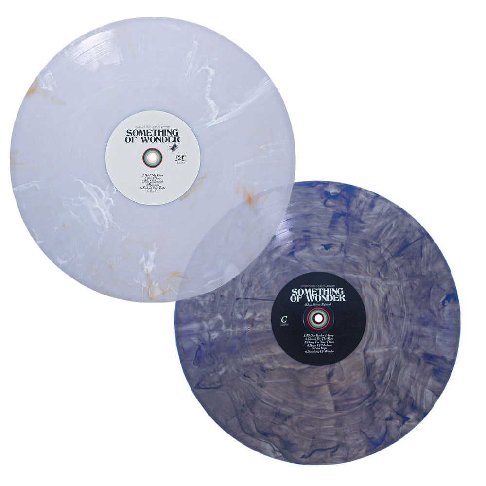 Two marbled vinyl records of World's First Cinema's debut, Something of Wonder. This double LP features white-beige swirl and blue-gray marbled discs—perfect for fans of Silver Screen-inspired cinematic soundscapes.