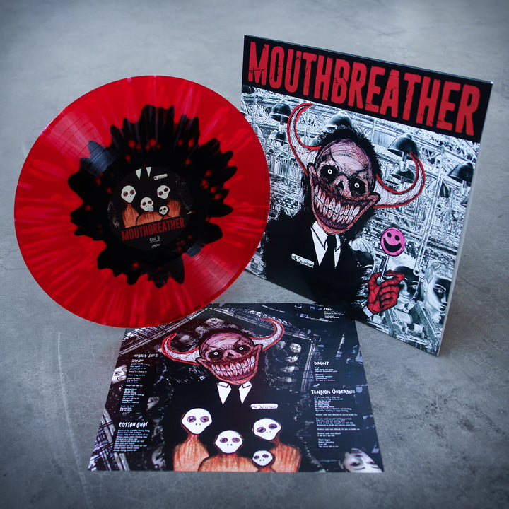 A red & black splatter vinyl by MouthBreather with a sinister horned cartoon on the cover, pink smiley face, Wasted Life album tracklist insert. Displayed on gray. Release date: 9/17/21.