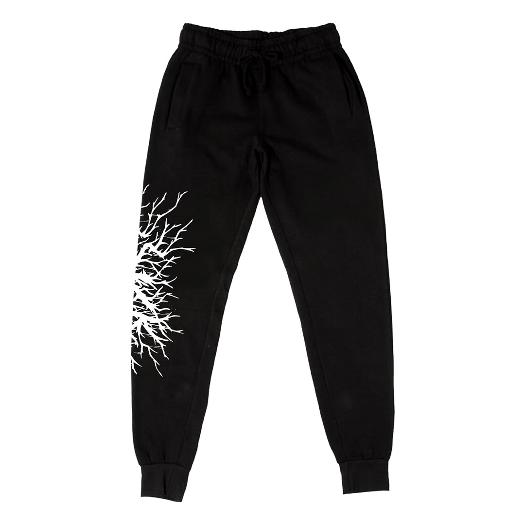 Stay Sick Clothing black jogger pants with elastic waistband and cuffs, featuring a white branch/root graphic on one upper thigh and a subtle Evil Logo detail.