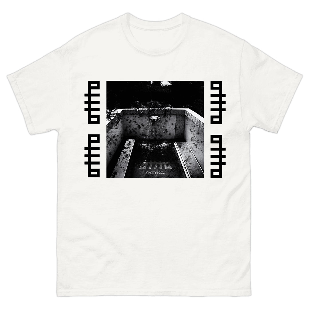 The OTTTO white t-shirt is crafted from soft cotton and showcases a black-and-white photo of an empty pool with debris, framed by bold geometric patterns. Available now for presale.
