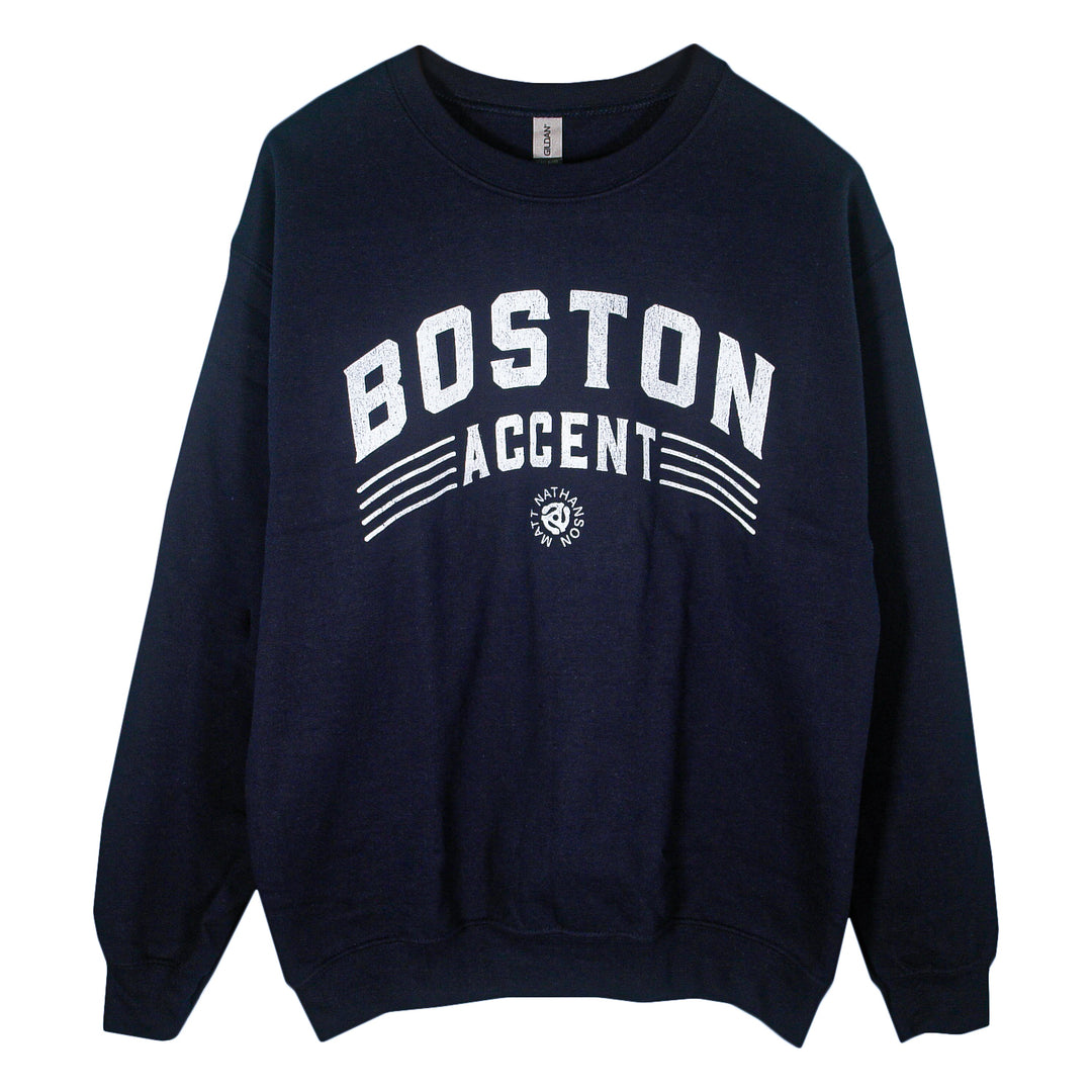 A navy blue Matt Nathanson crewneck sweatshirt features "BOSTON ACCENT" in bold white letters, with a small graphic and text below. Made from a heavy blend for added comfort and style.