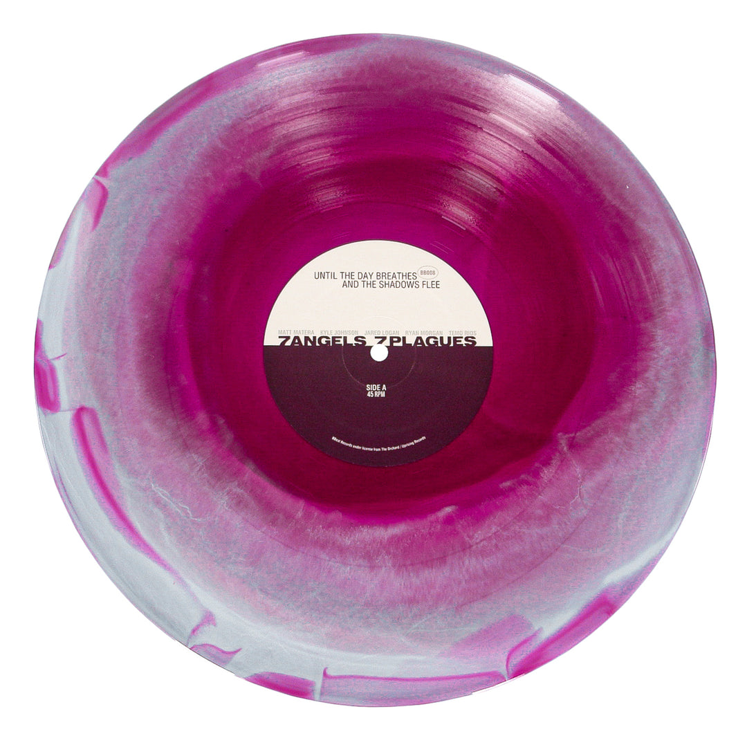 A marbled pink and white vinyl record by 7 Angels 7 Plagues, with a Tri Color Merge look. The black and white center label features the brand name, smaller text, and album details above and below.