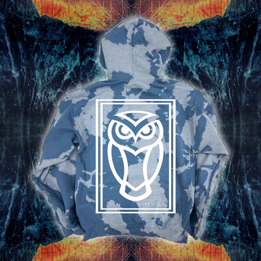 The Reflections brand hoodie features a blue and white bleach wash with a large, white owl outlined in a rectangle on the back over an abstract fiery blue background. Cozy fleece ensures warmth and comfort in this standout sweatshirt.