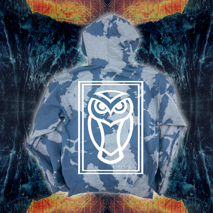 The Reflections brand hoodie features a blue and white bleach wash with a large, white owl outlined in a rectangle on the back over an abstract fiery blue background. Cozy fleece ensures warmth and comfort in this standout sweatshirt.