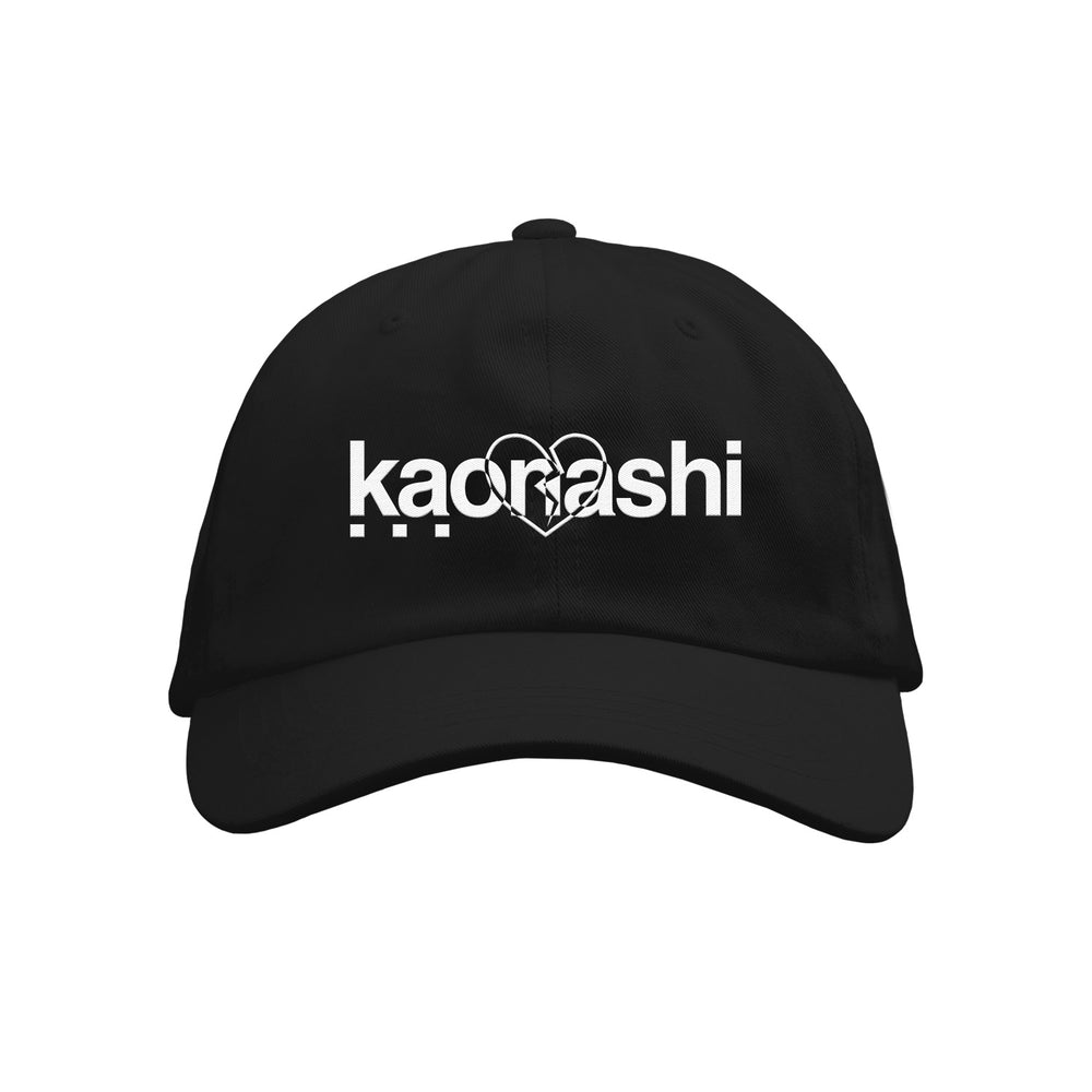 A black dad hat by Kaonashi features the brand name in bold white letters with a double heart outline overlapping the text. Three solid white dots below the left side complete this stylish accessory for any casual look.
