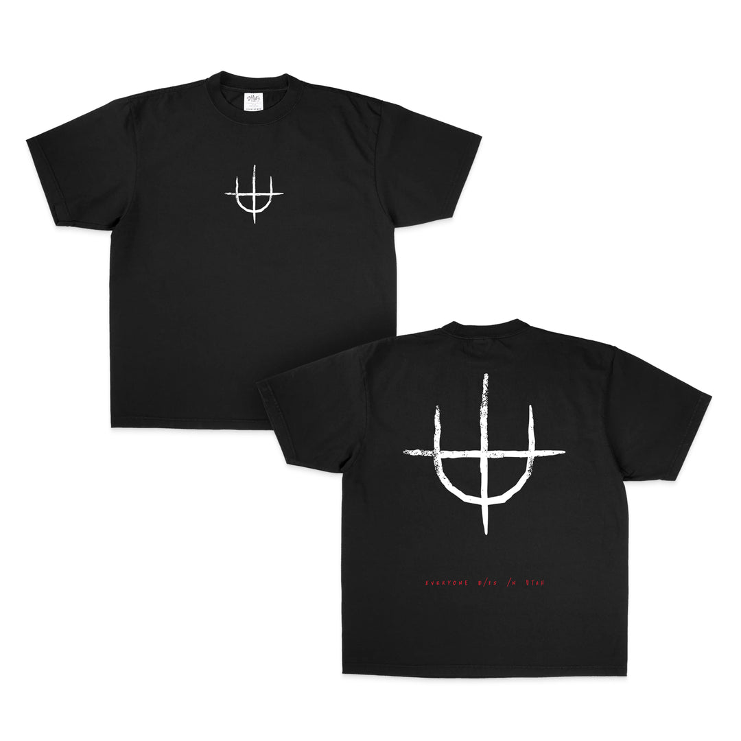 Everyone Dies In Utah black Shakawear T-shirt with a white abstract symbol on the front, a larger version on the back, and small red resurrect this is fire text near the hem—a bold choice for fans of standout printed tees.