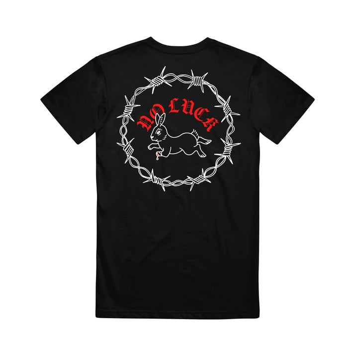 This Stay Sick Clothing Black T-Shirt showcases a white outline of a running rabbit surrounded by barbed wire, with bold red NO LUCK lettering above the design.