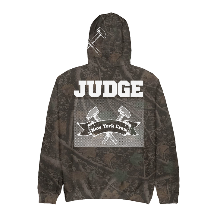 Back view of an IND4000 camouflage hoodie featuring a JUDGE and New York Crew banner graphic with crossed hammers.
