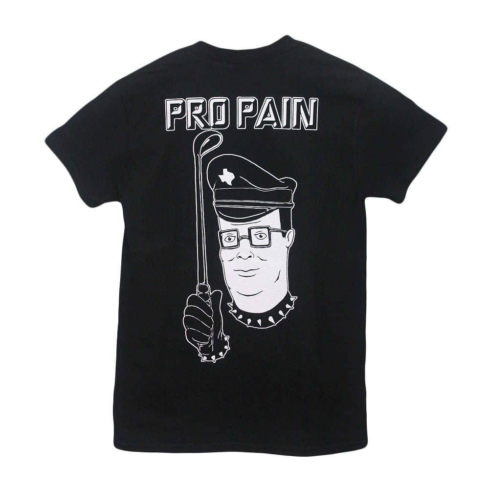 A black Castle Jackal t-shirt features a cartoon man in a police hat and spiked collar holding a crowbar, with “PRO PAIN” printed above him in bold white letters.