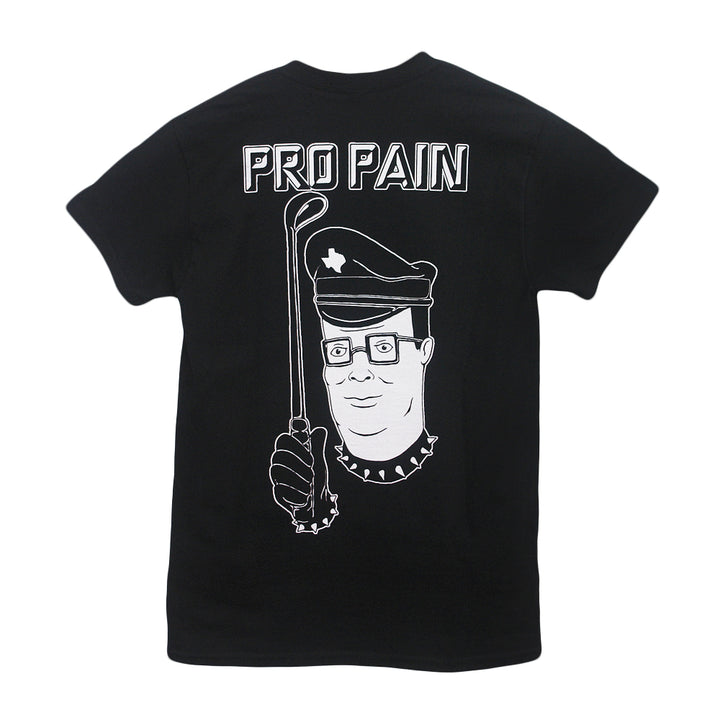 A black Castle Jackal t-shirt features a cartoon man in a police hat and spiked collar holding a crowbar, with “PRO PAIN” printed above him in bold white letters.