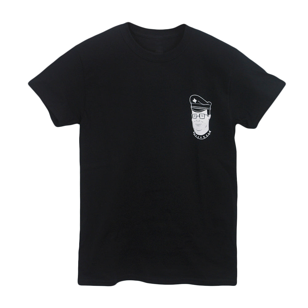 Castle Jackal black Comfort Colors t-shirt featuring a small white line drawing of a person with glasses, peaked cap, and chain necklace on the left chest. Available for pre-order.
