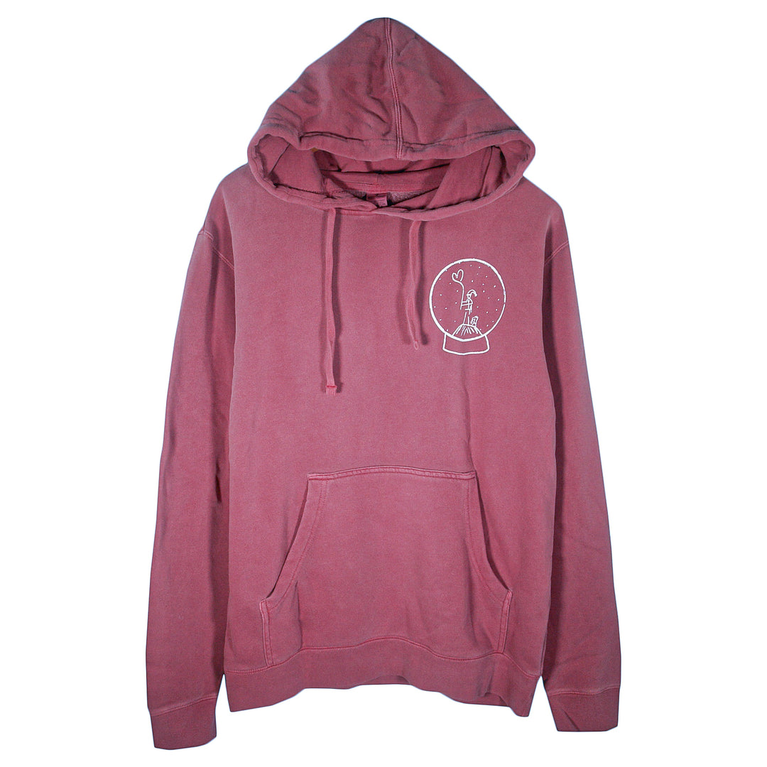 A maroon Matt Nathanson pigment-dyed pullover hoodie with a front pocket and drawstrings, featuring a small white peace sign hand in a snow globe graphic on the left chest.