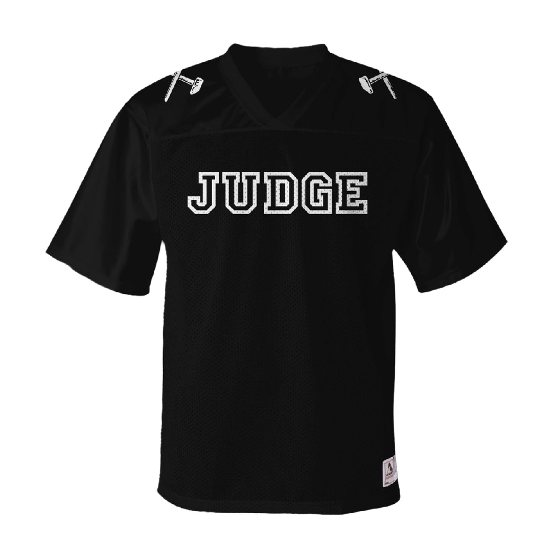 A black Judge replica football jersey made from polyester tricot mesh, featuring a v-neck collar, "JUDGE" in bold white letters on the chest, and two small white gavel graphics on the shoulders.