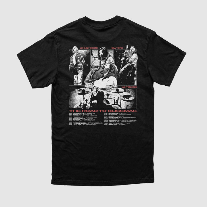 The Johnny Booth black t-shirt, made from Comfort Colors, features a white and red back graphic of four musicians performing with a drum set silhouette and "The Road to Blissmas" above tour dates—ideal for printed apparel fans.