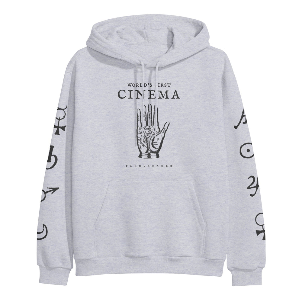 World's First Cinema light gray hoodie by Independent Trading Company features a palmistry hand graphic and "WORLDS FIRST CINEMA" on the front, black astrological symbols on both sleeves, a front pocket, drawstrings, and heavyweight fabric.