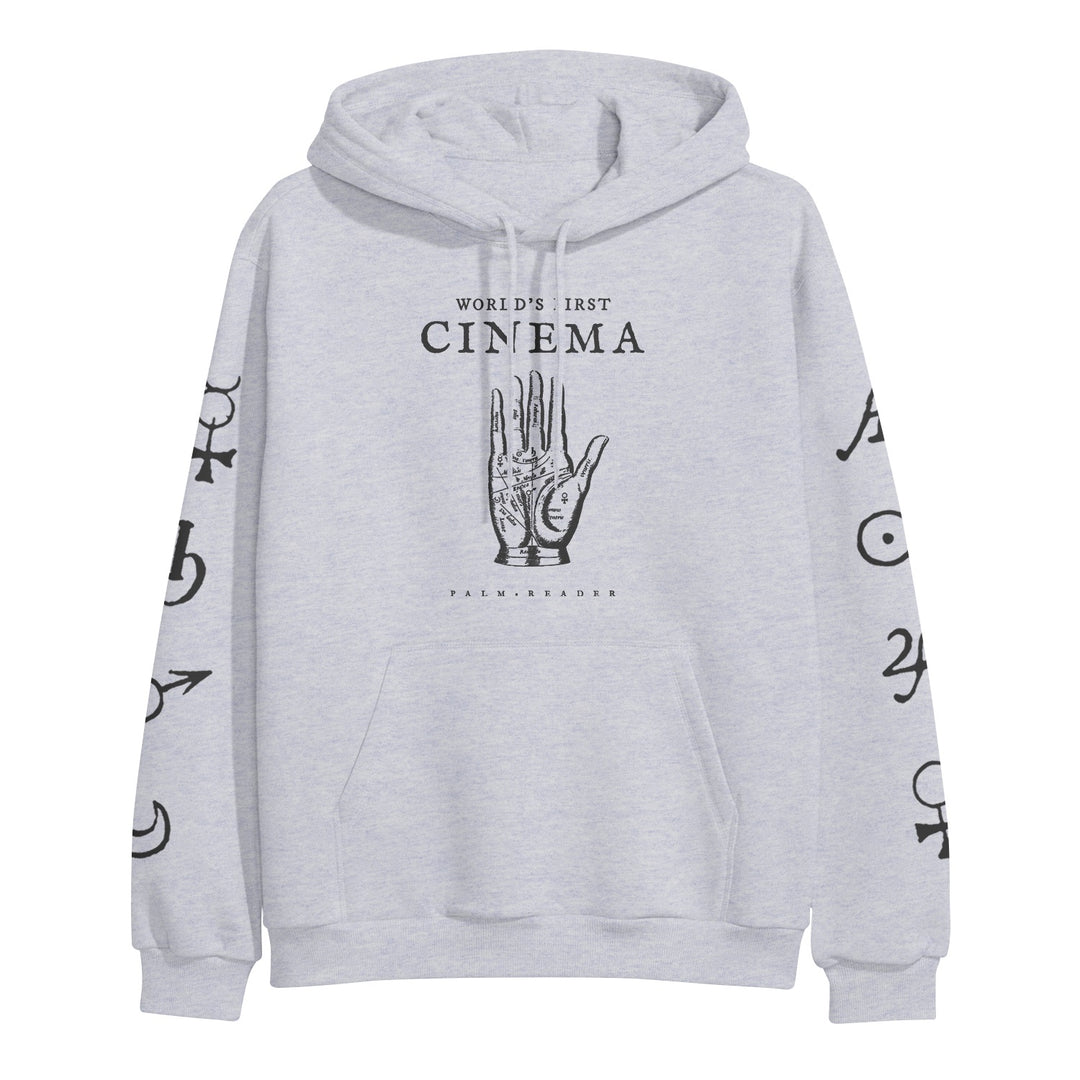 World's First Cinema light gray hoodie by Independent Trading Company features a palmistry hand graphic and "WORLDS FIRST CINEMA" on the front, black astrological symbols on both sleeves, a front pocket, drawstrings, and heavyweight fabric.