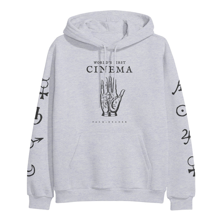World's First Cinema light gray hoodie by Independent Trading Company features a palmistry hand graphic and "WORLDS FIRST CINEMA" on the front, black astrological symbols on both sleeves, a front pocket, drawstrings, and heavyweight fabric.