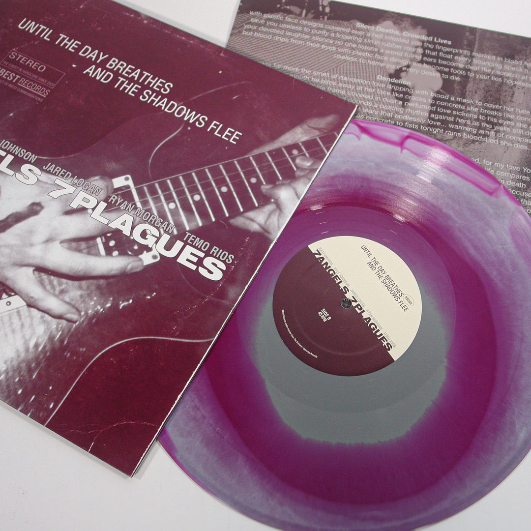 A purple and clear tri-color merge vinyl record by 7 Angels 7 Plagues, partially out of its sleeve featuring a close-up photo of someone playing guitar. The label and sleeve read "Until the Day Breathes and the Shadows Flee.