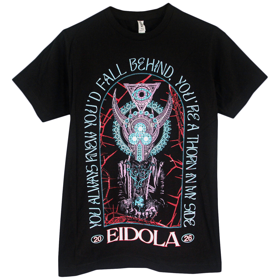 Black t-shirt by Eidola with a detailed, surreal horned mechanical figure and geometric patterns. Text: YOU ALWAYS KNEW YOU’D FALL BEHIND, YOU’RE A THORN AT MY SIDE. “EIDOLA” and “20 26 persevere” at the bottom.
