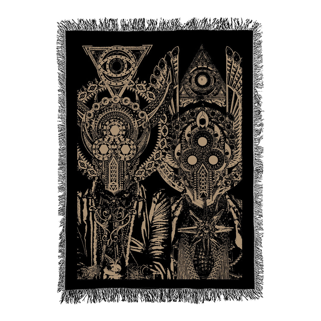 The Eidola woven tapestry blanket showcases two abstract, symmetrical figures with detailed geometric patterns and circles on a black background, finished with a fringed border—ideal as a custom or personalized blanket.