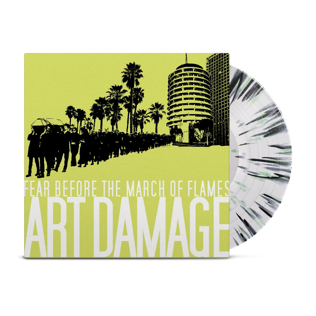 A vinyl record partially slides from its sleeve. This limited edition LP by Fear Before features black silhouettes of people, palm trees, and buildings on a yellow cover with Fear Before Art Damage displayed prominently.