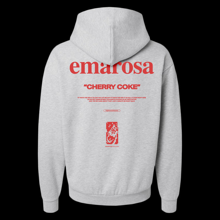 A gray Unisex Avenue Hooded Sweatshirt by Emarosa featuring a bold red emarosa logo, “CHERRY COKE” in quotes, smaller red text on the back, and a pixel-style cherry can graphic at the bottom.