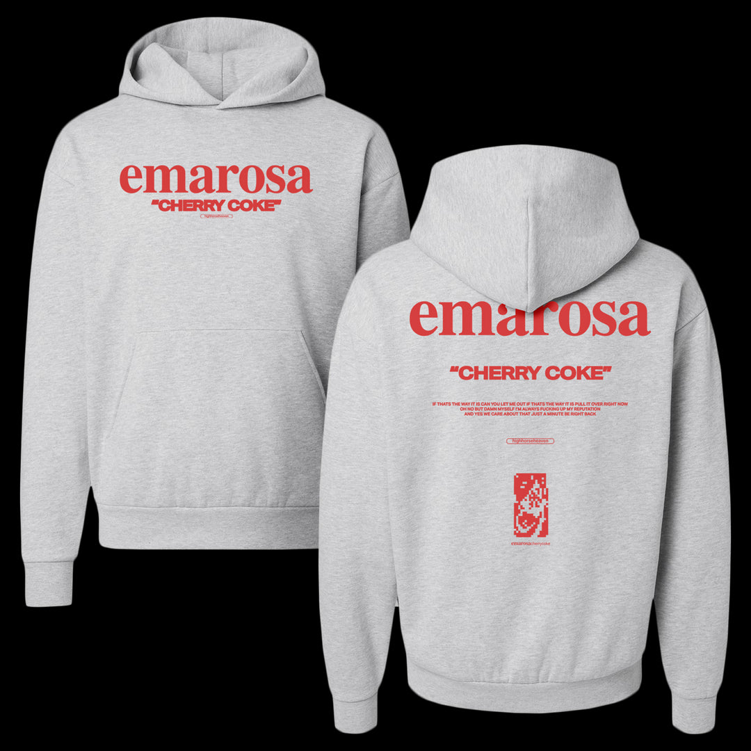A gray Unisex Avenue Hooded Sweatshirt by Emarosa with bold red "emarosa CHERRY COKE" text on the front. The back features matching text, small print, graphic details, and a website link on a plain background.