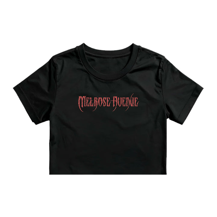 A black Melrose Avenue crop tee by ASColour 4062, made from 100% combed cotton, features bold red gothic-style "MELROSE AVENUE" lettering on the front.