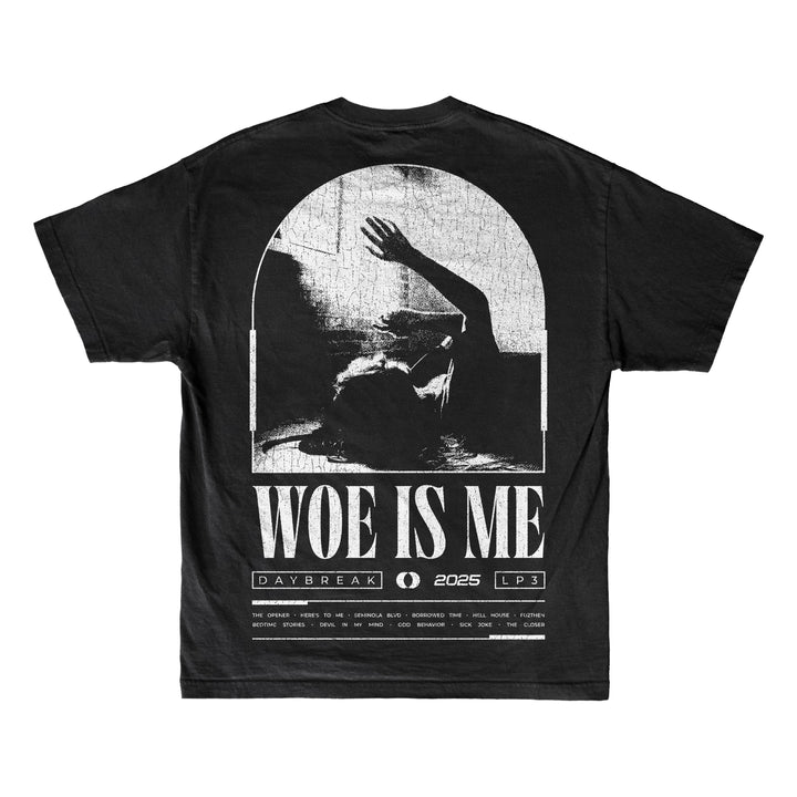 Woe Is Me black T-shirt with a grayscale figure reaching up inside an arched window, bold Woe Is Me text, and smaller details: DAYBREAK, 2025, LP3.