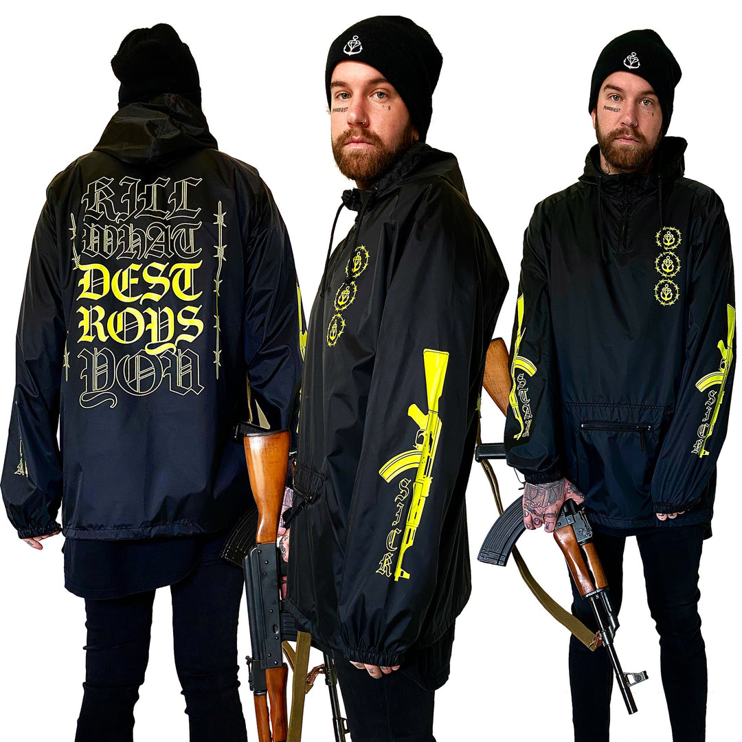 Three views of a man in a Stay Sick Clothing black beanie and Gang Black Pullover with bold yellow graphics, holding a rifle. The back of the windbreaker reads “KILL WHAT DESTROYS YOU.”.