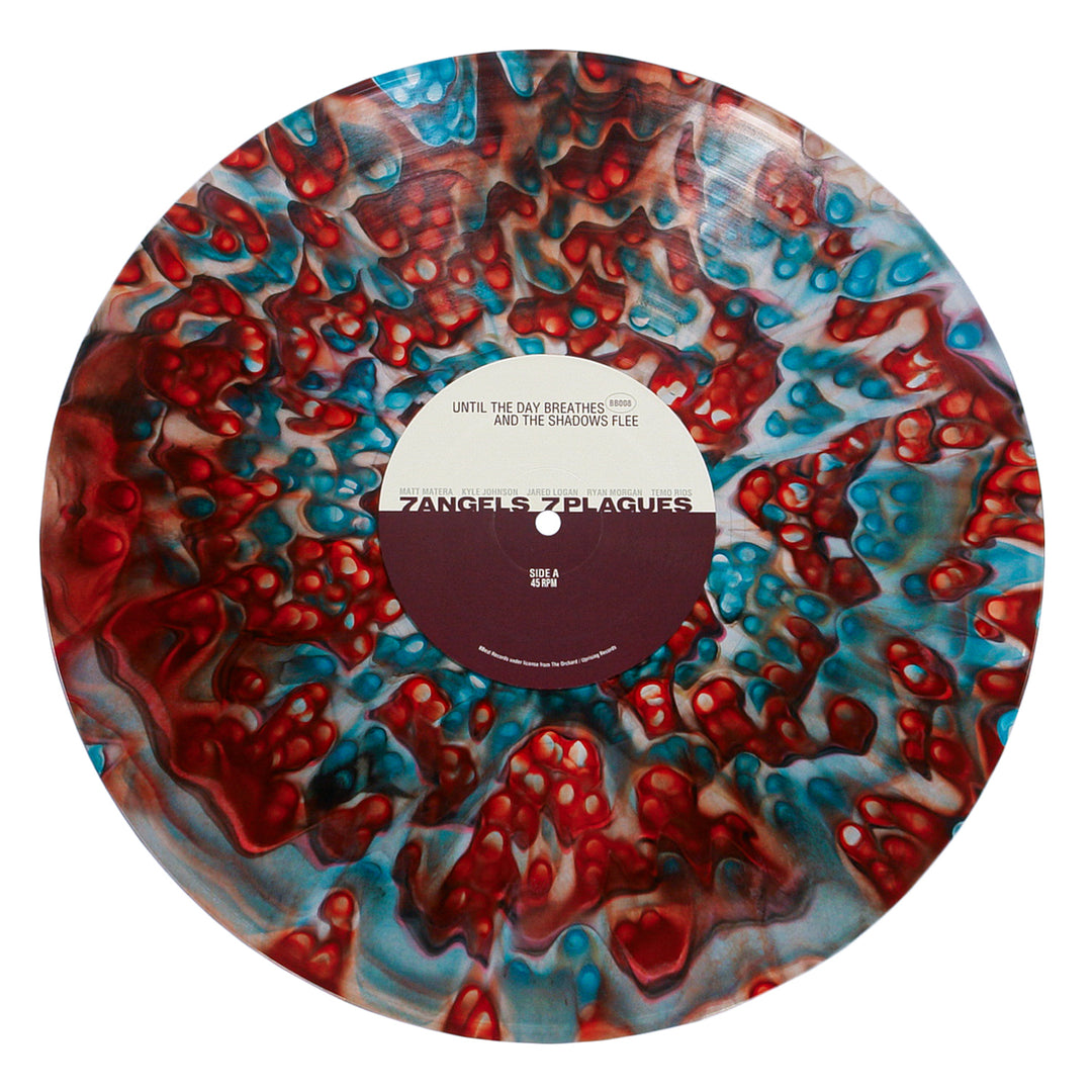 A deluxe marbled red, blue, and white vinyl record from 7 Angels 7 Plagues, featuring track titles like "Until The Day Breathes" and album info on the center label.