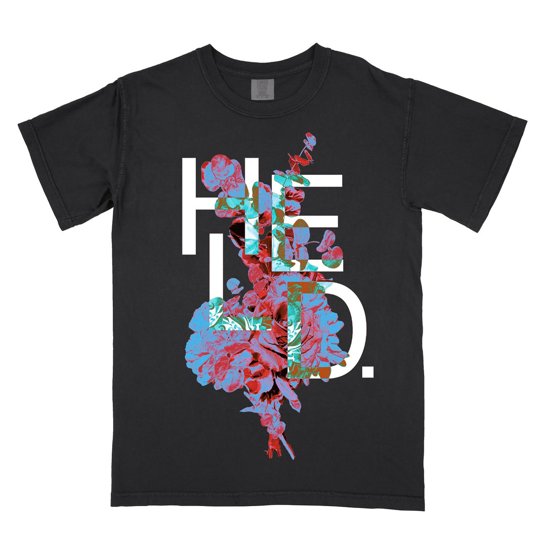 Black T-shirt with the word HEAD. in large white letters, partially covered by a colorful floral design featuring blue and pink flowers. Crafted from soft ring-spun cotton and garment-dyed for a lived-in feel, this Comfort Colors T-Shirt combines standout style with all-day comfort.
