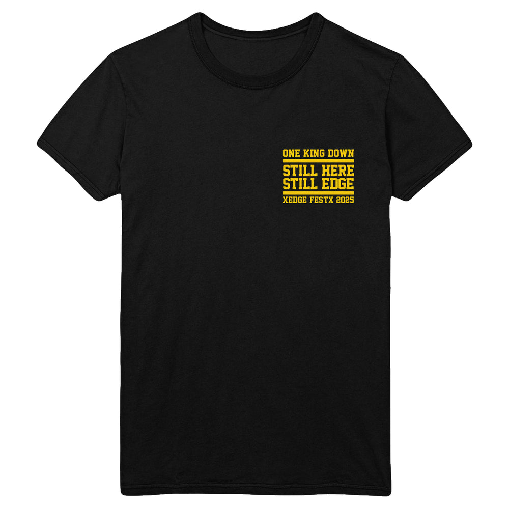 One King Down black Gildan heavy cotton t-shirt features bold yellow stacked text—“ONE KING DOWN, STILL HERE, STILL EDGE, XEDGE FESTX 2025”—on the left chest, perfect for fans of quality printed apparel.