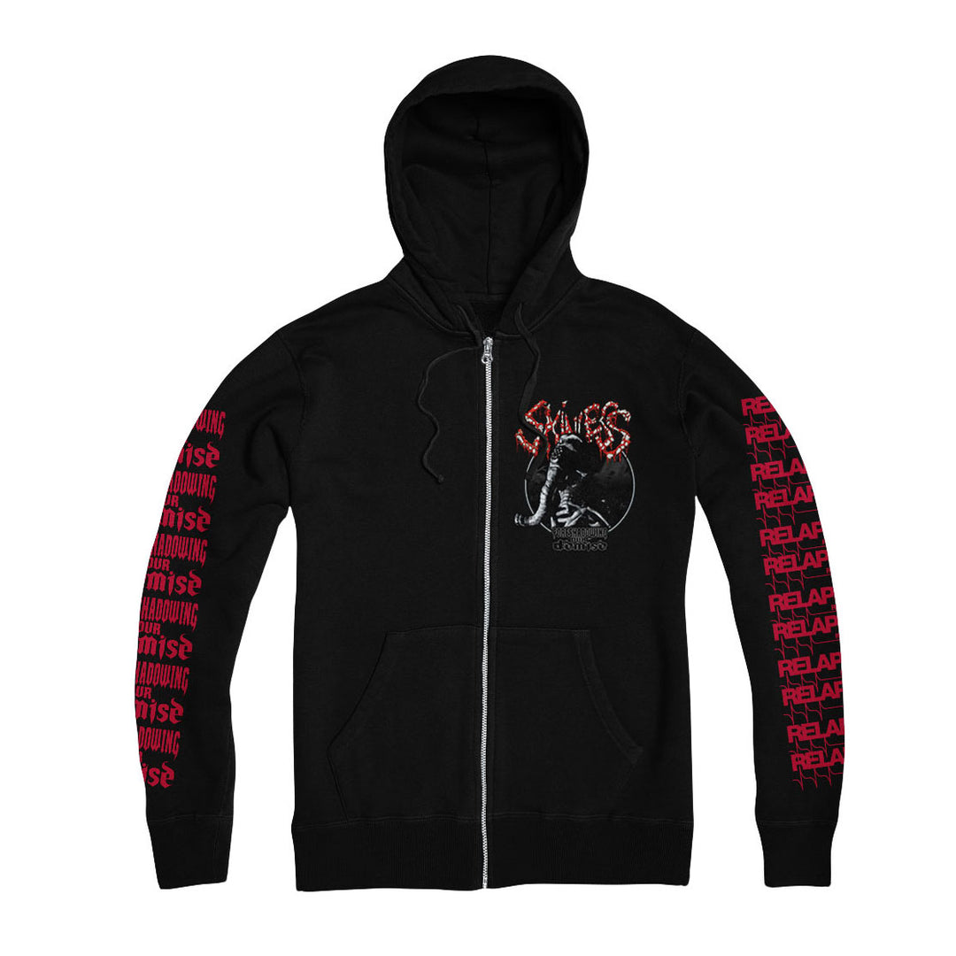 The Skinless black zip-up hoodie features bold red "RELEASE" text on both sleeves, a wolf, moon, and "SKILLET" graphic, two front pockets, and adjustable drawstrings. Made from premium Independent Trading garments.