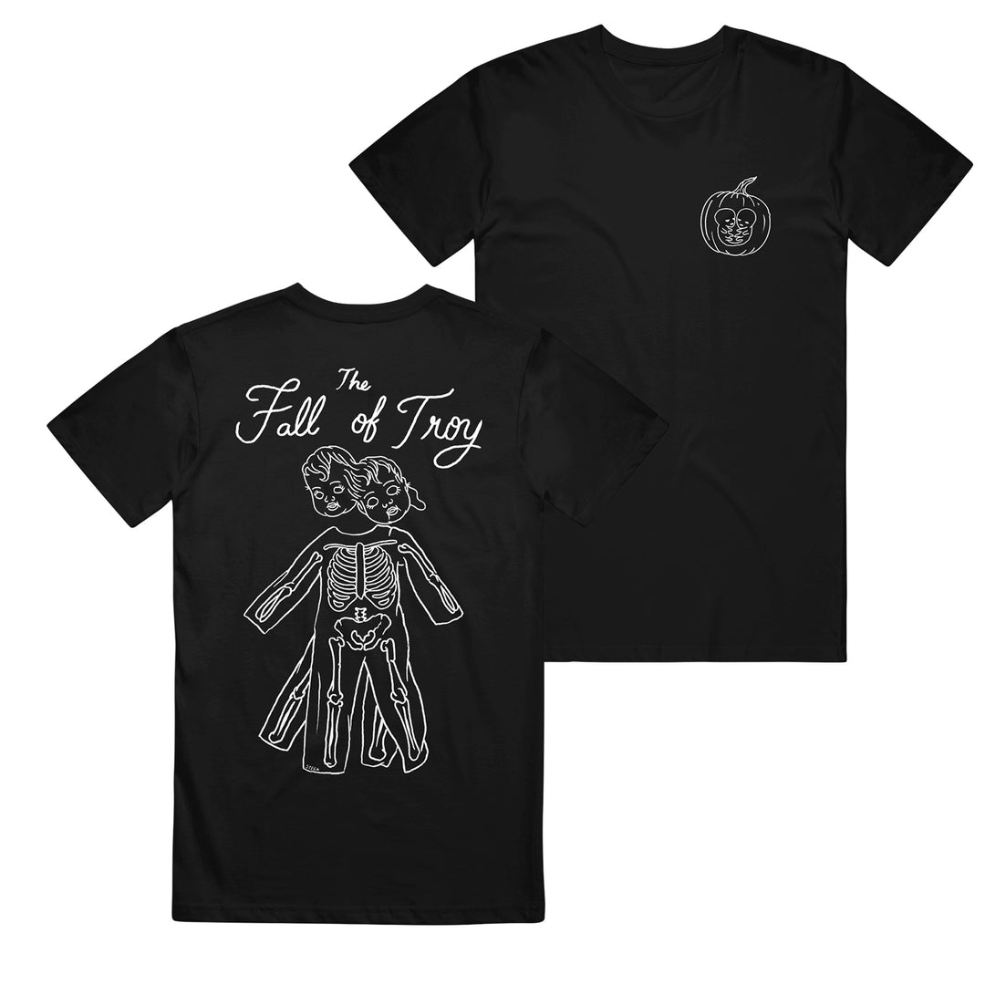 The Fall of Troy black t-shirt features white line art: a small apple and face graphic on the front, and a three-headed doll with visible skeleton on the back under The Fall of Troy text. Made from quality American Apparel for comfort and style.