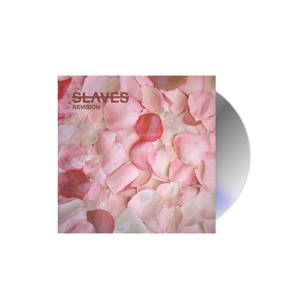 A partially visible CD in a square case, featuring overlapping pink and white rose petals on the cover and the brand name Slaves with the title “SLAVE’S REVISION” in the top left corner.